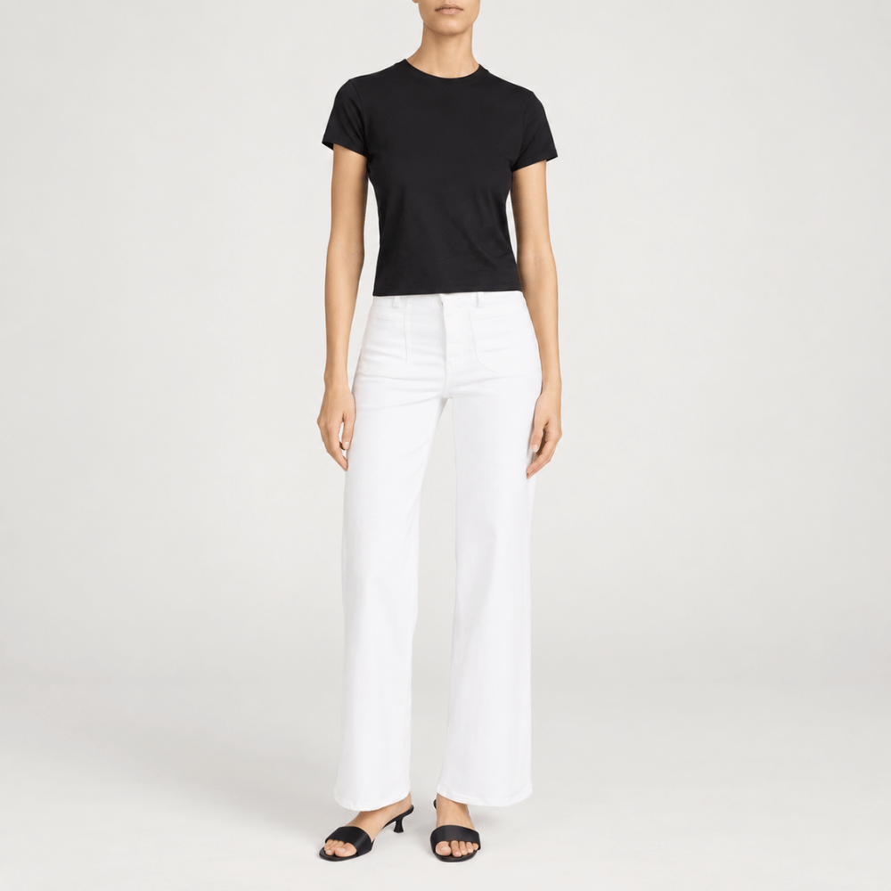 FRAME Le Slim Palazzo Modernist Pocket Jeans in White at Riada Concept. High-rise wide-leg stretch denim with flat patch pockets - full front view styled model