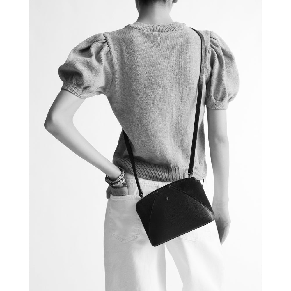 Henry Beguelin Volta Small leather and suede crossbody bag worn across the body, model view