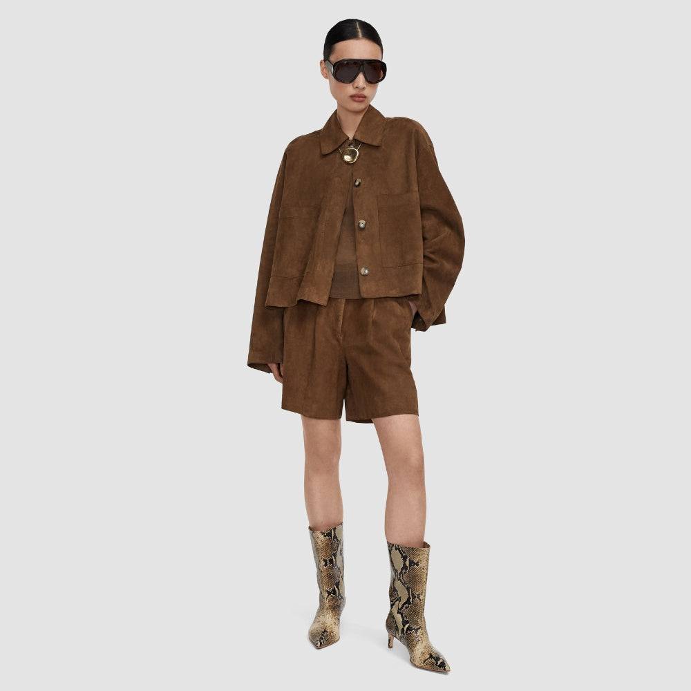 Model wearing the JOSEPH Aitna suede jacket in taupe over matching suede shorts, full length
