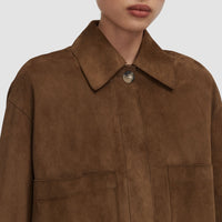 Close-up of the JOSEPH Aitna suede jacket's pointed collar and concealed placket in taupe