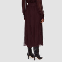 Back view of the JOSEPH Ale silk chiffon trousers in mahogany, worn with the matching blouse