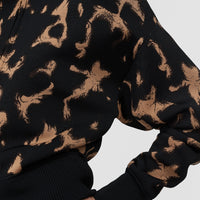 Close-up of the JOSEPH Ambra jacket's tortoiseshell jacquard and ribbed cuff