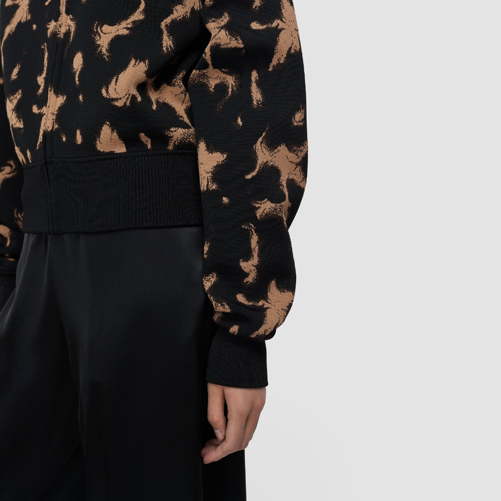 Detail of the JOSEPH Ambra knit bomber's ribbed hem and full sleeve