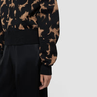 Detail of the JOSEPH Ambra knit bomber's ribbed hem and full sleeve