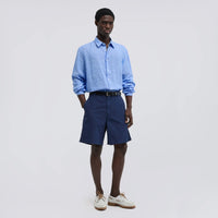 Aspesi Comma linen shirt in sky blue worn by a model with navy shorts and white boat shoes