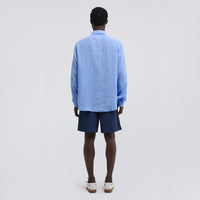 Close-up of the Aspesi Comma shirt's point collar and textured sky blue linen
