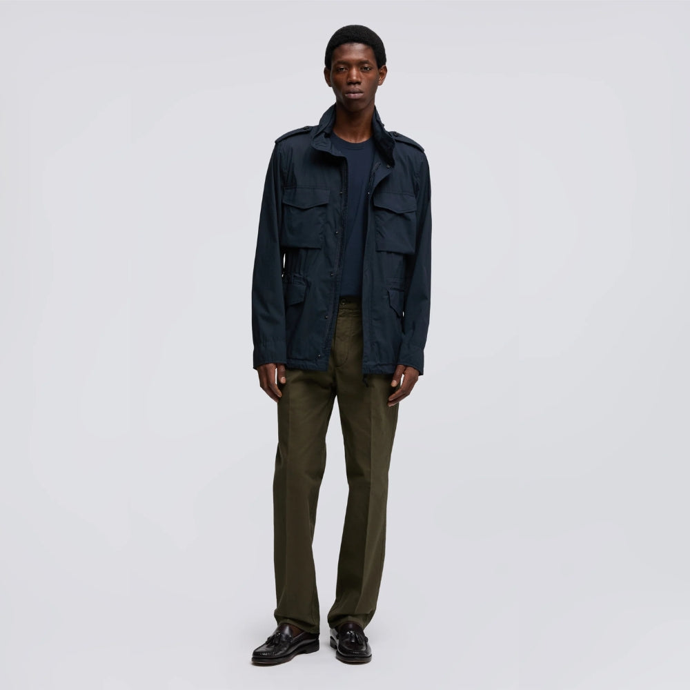 Aspesi Minifield field jacket in navy worn by a model with olive trousers and black loafers