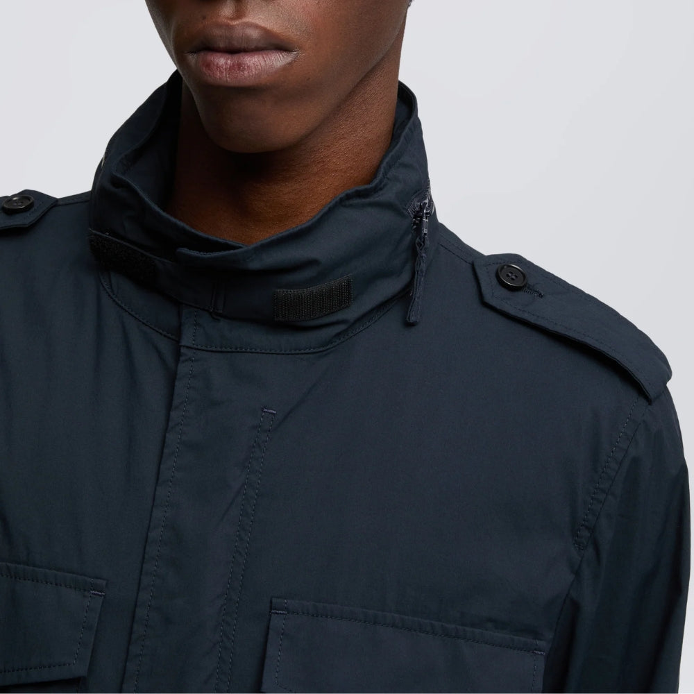 Close-up of the Aspesi Minifield navy field jacket collar, with hood zip, hook-and-loop tab and buttoned epaulette