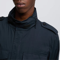 Close-up of the Aspesi Minifield navy field jacket collar, with hood zip, hook-and-loop tab and buttoned epaulette
