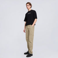 Aspesi Revisited Trekking Trousers in colonial beige worn by a model with a black T-shirt and loafers