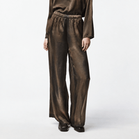 Shop Avant Toi’s hand-painted silk palazzo pants in Yak. Fluid wide-leg trousers with stretch and an elasticated waist - front close up model view