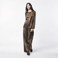 Shop Avant Toi’s hand-painted silk palazzo pants in Yak. Fluid wide-leg trousers with stretch and an elasticated waist - front model view