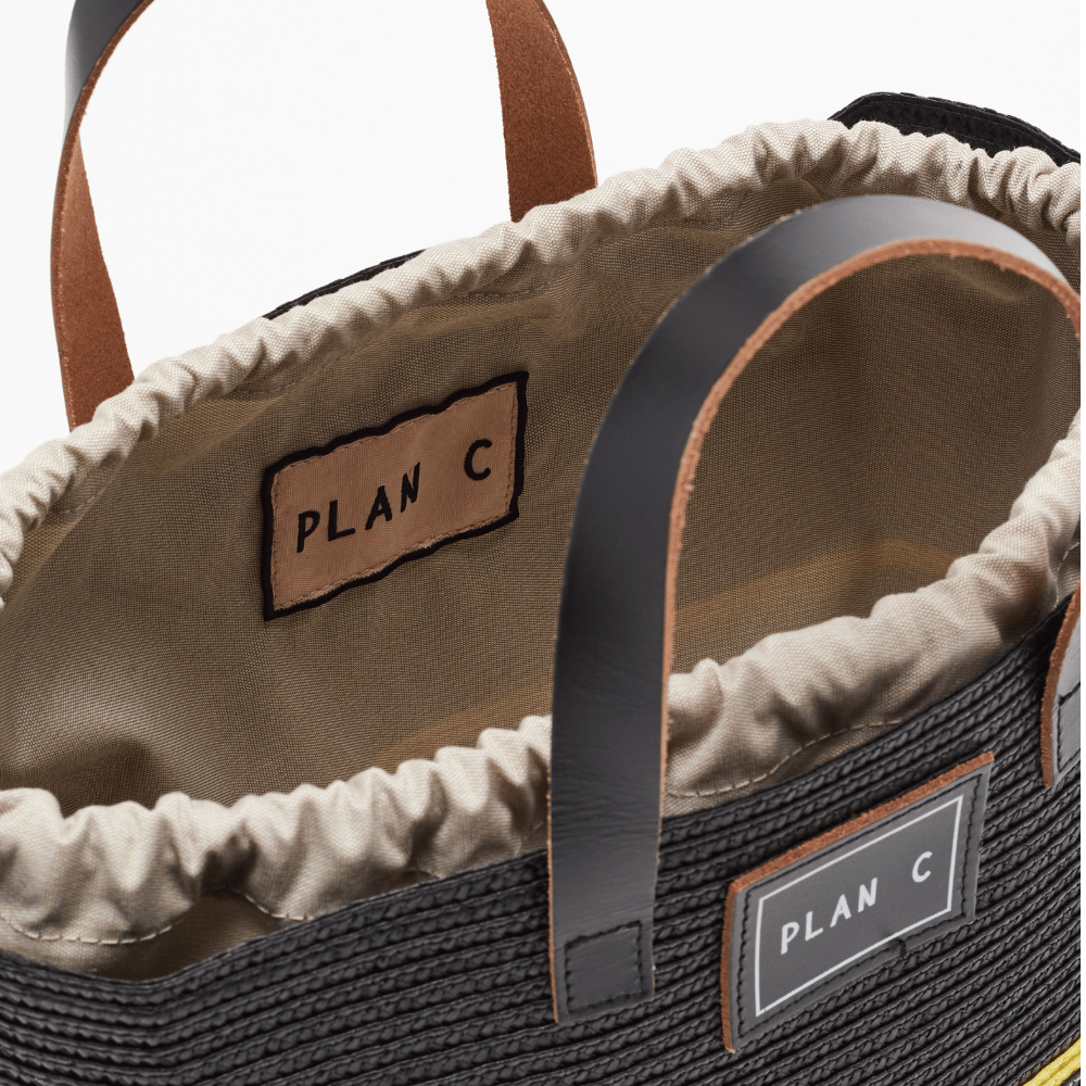 Plan C black woven tote bag interior with cream drawstring lining and leather handles