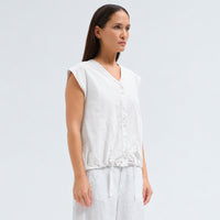 A white cotton shirt by Transit Par Such with a collarless V-neck, button front, cap sleeves and a drawstring hem for a boxy, cropped shape - side view