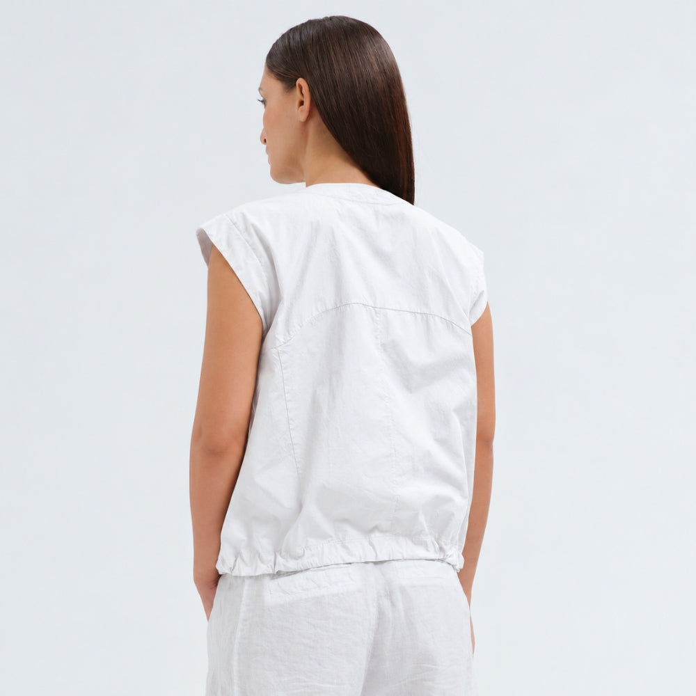 A white cotton shirt by Transit Par Such with a collarless V-neck, button front, cap sleeves and a drawstring hem for a boxy, cropped shape - back view