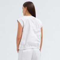 A white cotton shirt by Transit Par Such with a collarless V-neck, button front, cap sleeves and a drawstring hem for a boxy, cropped shape - back view