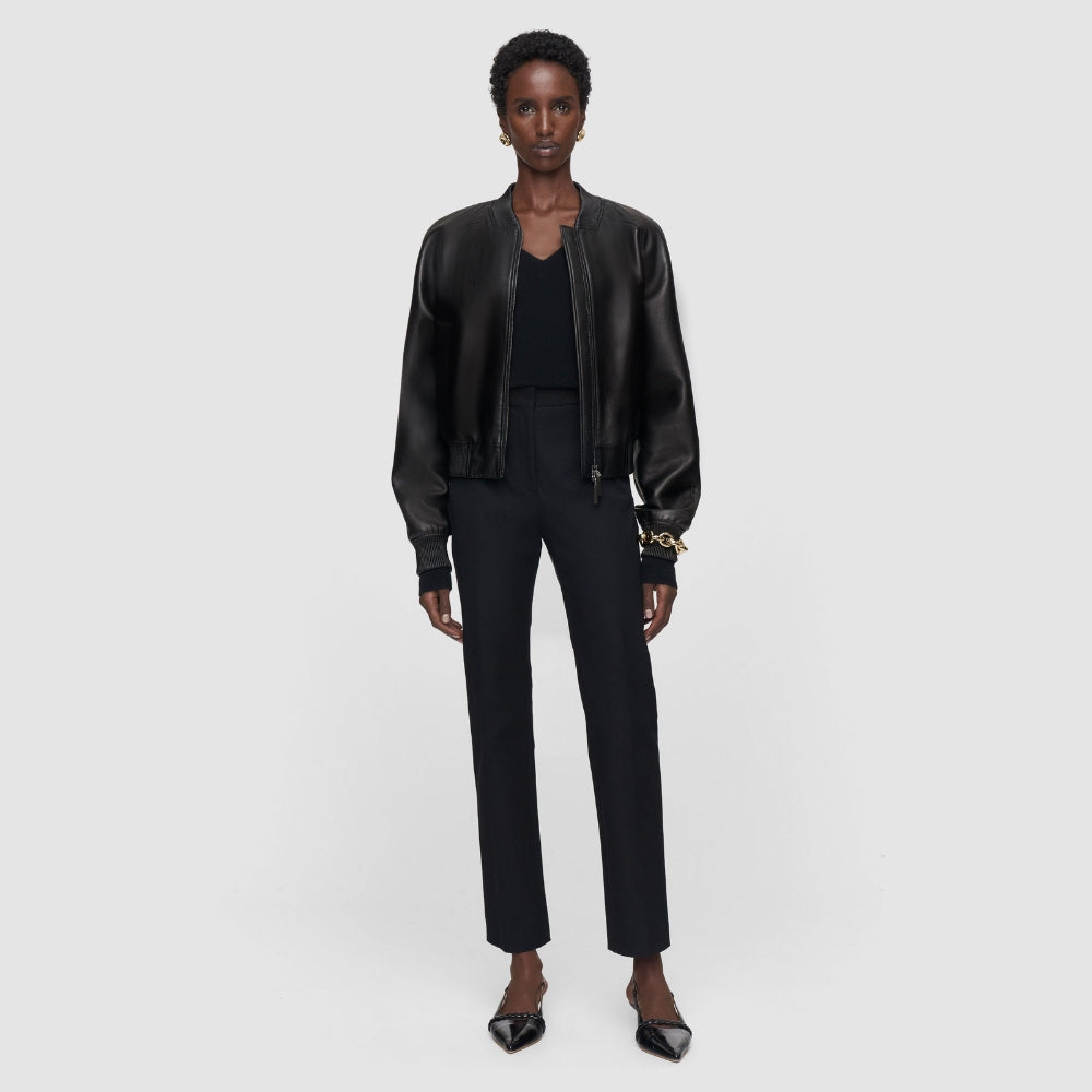 Model wearing the JOSEPH Coleman Long black trousers with a leather bomber jacket, full length