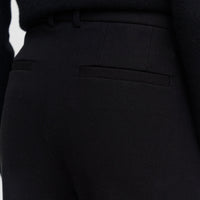 Close-up of the JOSEPH Coleman Long trousers' jetted back pocket and belt loops