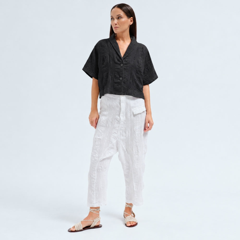 A boxy, cropped kimono jacket by Transit Par Such in black embossed cotton and linen jacquard, with a shawl collar and wide short sleeves - full model front view