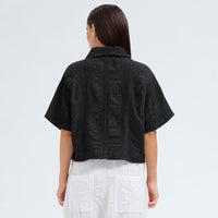 A boxy, cropped kimono jacket by Transit Par Such in black embossed cotton and linen jacquard, with a shawl collar and wide short sleeves - back view