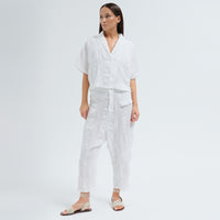 A boxy, cropped kimono jacket by Transit Par Such in white embossed cotton and linen jacquard, with a shawl collar and wide short sleeves - full front model view