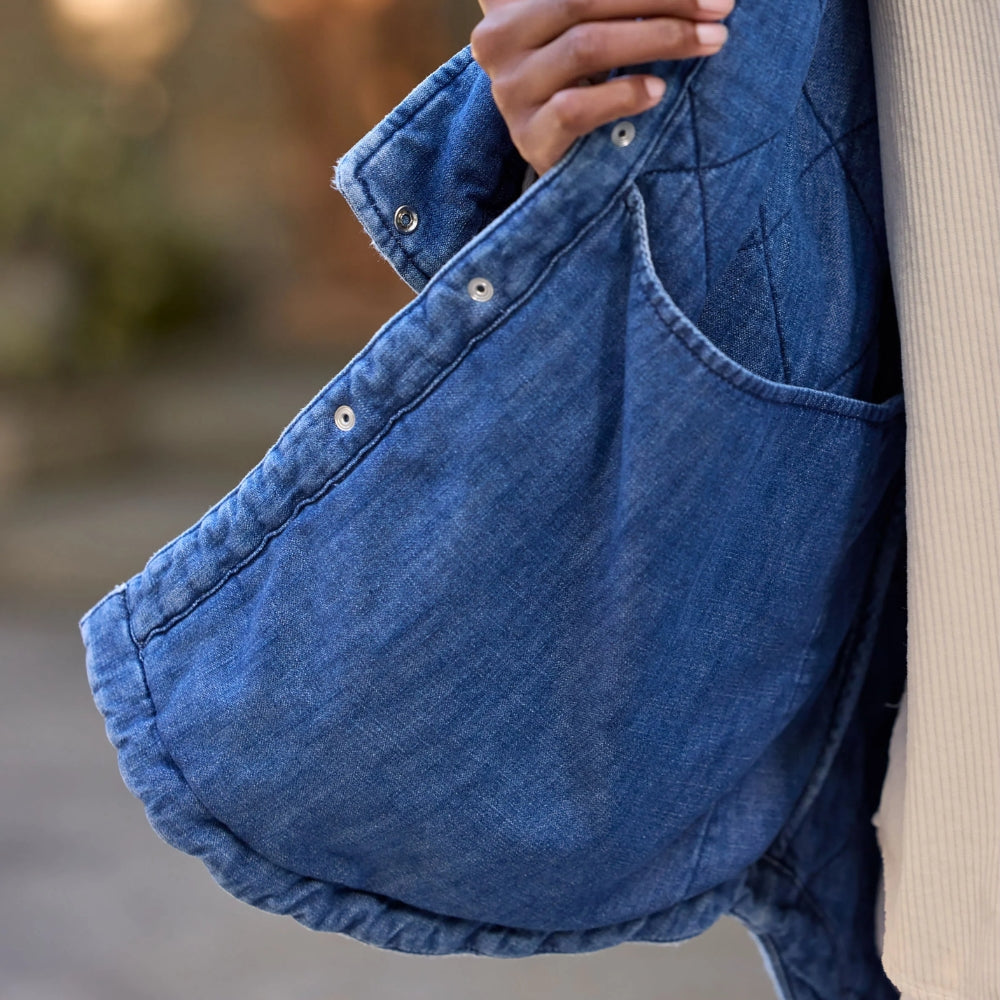 Frank & Eileen Eileen Quilted Shirt Jacket in distressed indigo diamond-quilted denim - close-up hem detail