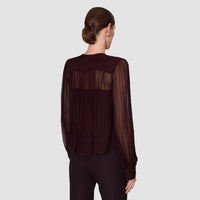 Back view of the JOSEPH Elisa silk chiffon blouse in mahogany, showing the yoke and sheer sleeves