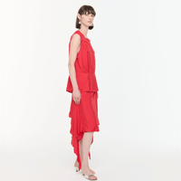 Plan C Asymmetric Viscose Skirt in Fire Red styled on model with draped asymmetric hem - side view