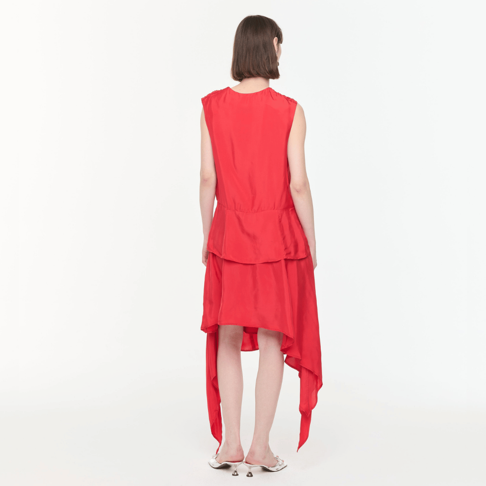 Plan C Asymmetric Viscose Skirt in Fire Red styled on model with draped asymmetric hem - back view