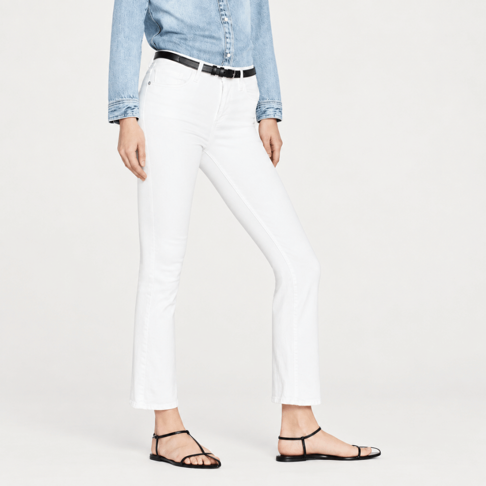 FRAME Le Crop Mini Boot jeans in Blanc at Riada Concept. High-rise white cropped bootcut jeans in soft comfort-stretch denim - angle view