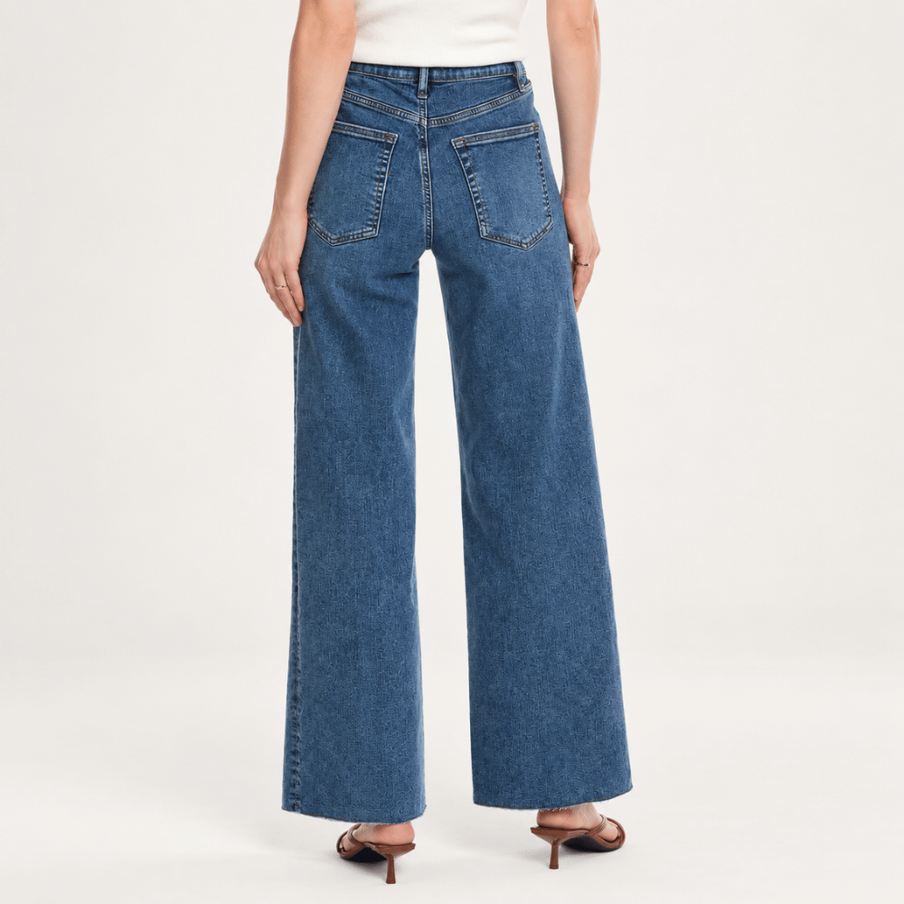 Model back FRAME Le Slim Palazzo Jeans in Canals at Riada Concept. High-rise, full-length wide-leg denim with a raw hem. Shop online Australia-wide or in Sydney.