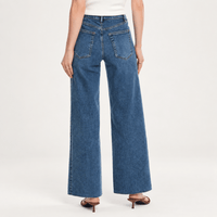 Model back FRAME Le Slim Palazzo Jeans in Canals at Riada Concept. High-rise, full-length wide-leg denim with a raw hem. Shop online Australia-wide or in Sydney.