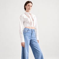 Model view FRAME Le Slim Palazzo Raw Fray Jeans in Clearwater at Riada Concept. High-rise, light-blue wide-leg stretch denim. Shop Australia-wide or in Sydney.