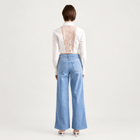 Model back view - FRAME Le Slim Palazzo Raw Fray Jeans in Clearwater at Riada Concept. High-rise, light-blue wide-leg stretch denim. Shop Australia-wide or in Sydney.