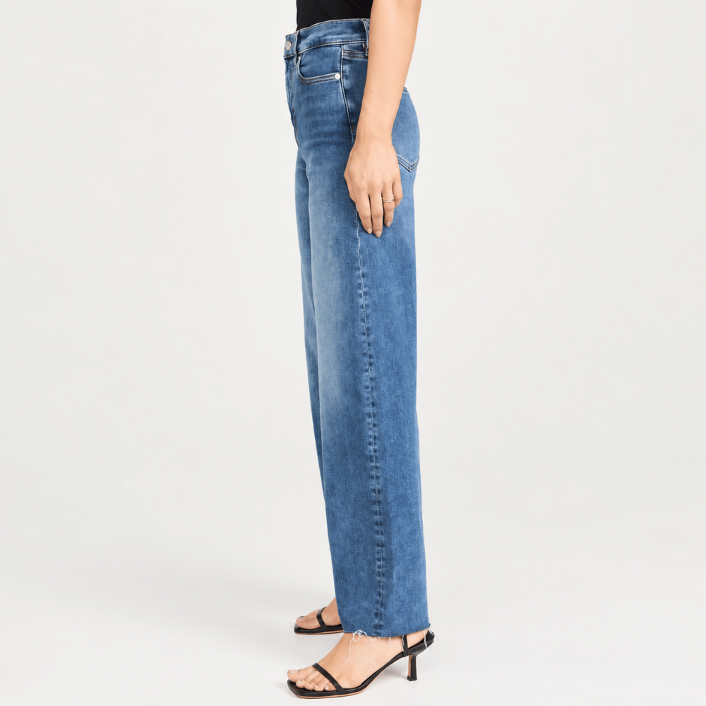 FRAME Le Slim Palazzo Raw Fray Jeans in Mermaid at Riada Concept. High-rise medium-blue wide-leg stretch denim with raw hem. - side view