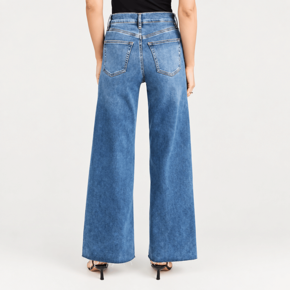 FRAME Le Slim Palazzo Raw Fray Jeans in Mermaid at Riada Concept. High-rise medium-blue wide-leg stretch denim with raw hem - back view
