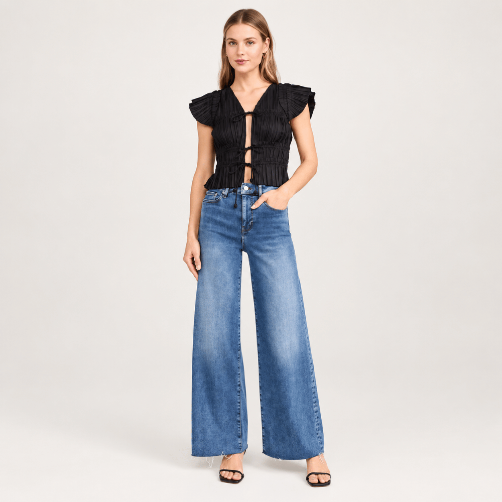 FRAME Le Slim Palazzo Raw Fray Jeans in Mermaid at Riada Concept. High-rise medium-blue wide-leg stretch denim with raw hem - styled model front view