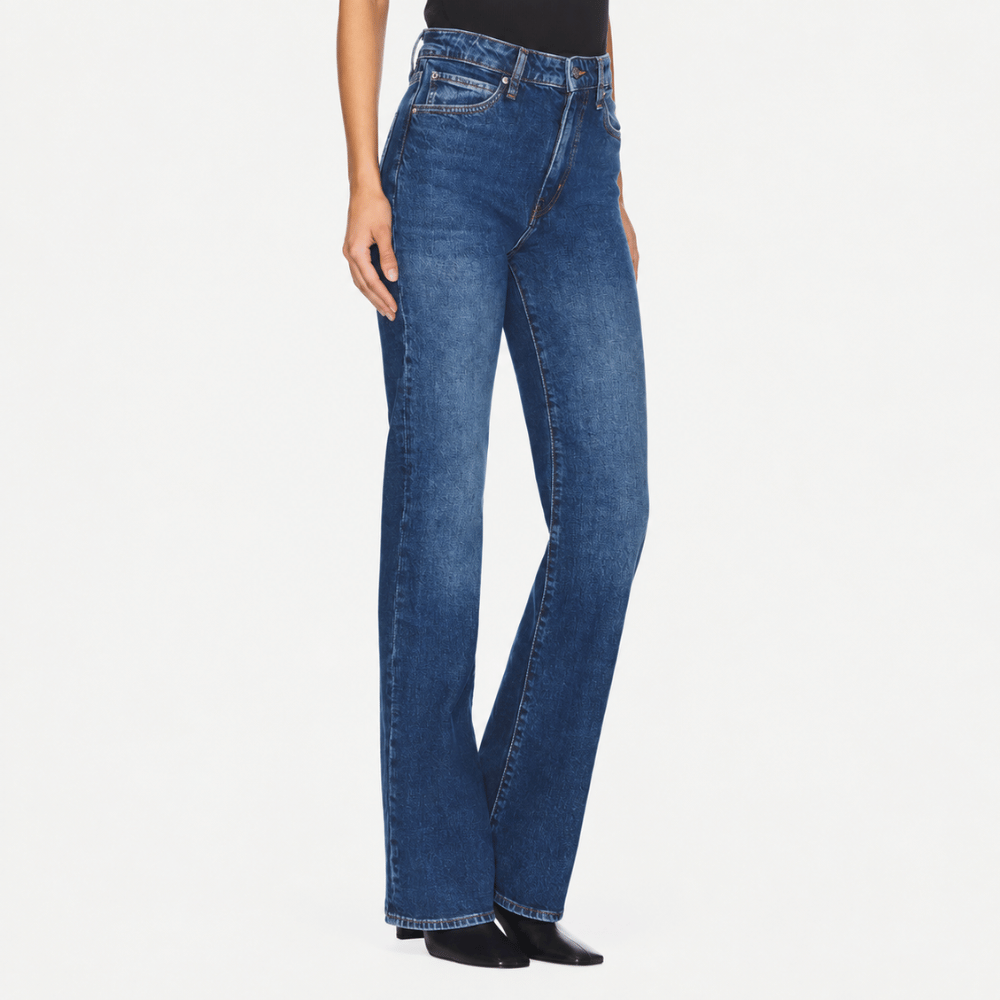 FRAME The Arrow jeans in Rival at Riada Concept. High-rise blue bootcut jeans in comfort-stretch denim with a 33-inch inseam - angle view