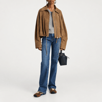 FRAME The Arrow jeans in Rival at Riada Concept. High-rise blue bootcut jeans in comfort-stretch denim with a 33-inch inseam - full front view of styled model