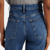 Close-up of FRAME The Arrow jeans in Rival at Riada Concept. High-rise blue bootcut jeans in comfort-stretch denim with a 33-inch inseam - back view showing waistband and back pockets