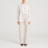 FRAME The Bow Cargo Jeans in Flax at Riada Concept. High-rise rigid denim with flat utility pockets and a sculpted barrel leg - front styled model view