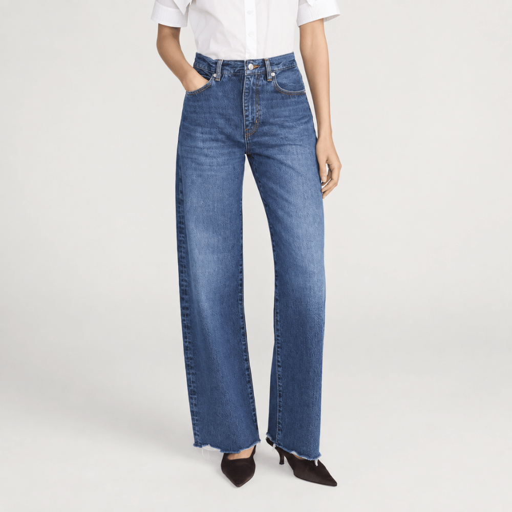 FRAME The Bow Jeans in Acumen New Fray at Riada Concept. High-rise rigid denim with a sculpted barrel leg and raw frayed hem - front view
