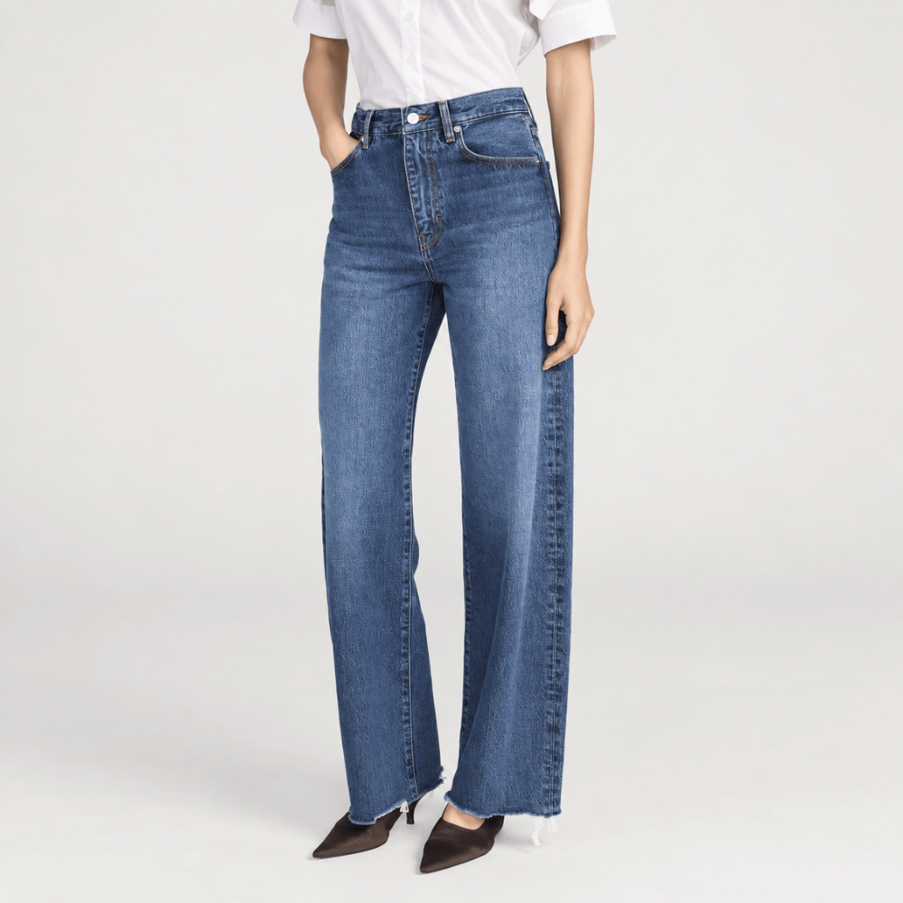 FRAME The Bow Jeans in Acumen New Fray at Riada Concept. High-rise rigid denim with a sculpted barrel leg and raw frayed hem - angle view
