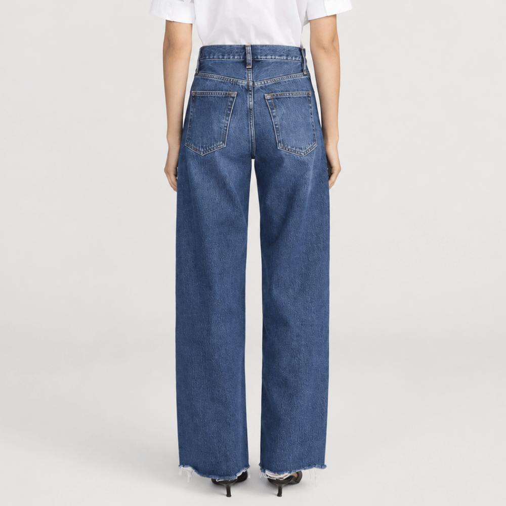 FRAME The Bow Jeans in Acumen New Fray at Riada Concept. High-rise rigid denim with a sculpted barrel leg and raw frayed hem - back view