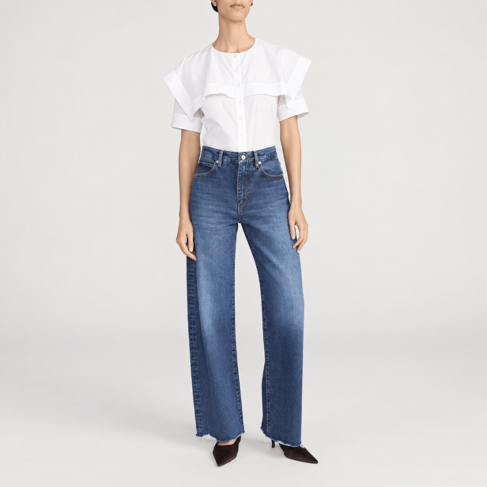 FRAME The Bow Jeans in Acumen New Fray at Riada Concept. High-rise rigid denim with a sculpted barrel leg and raw frayed hem - front model view