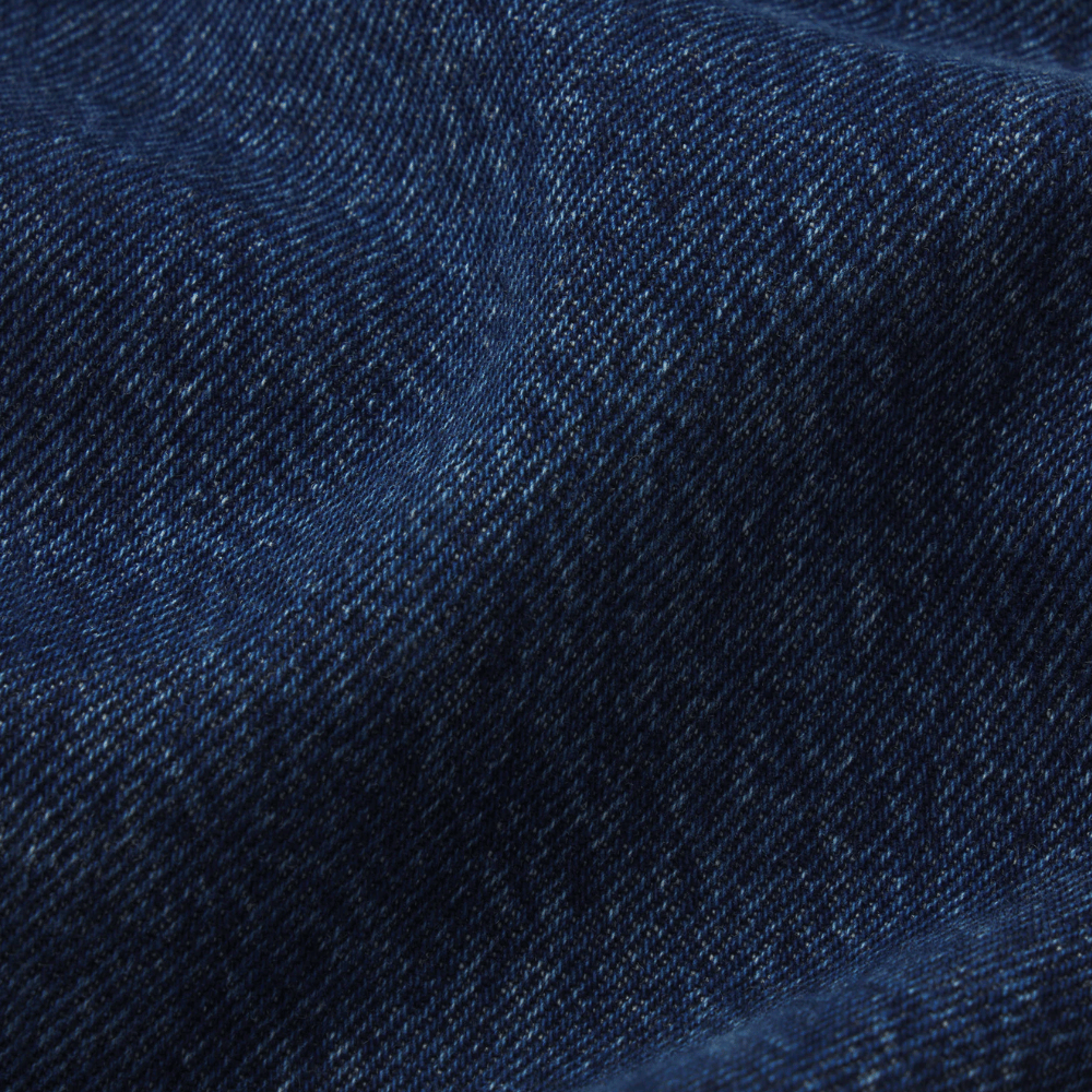 FRAME The Bow Jeans in Acumen New Fray at Riada Concept. High-rise rigid denim with a sculpted barrel leg and raw frayed hem - close-up fabric texture