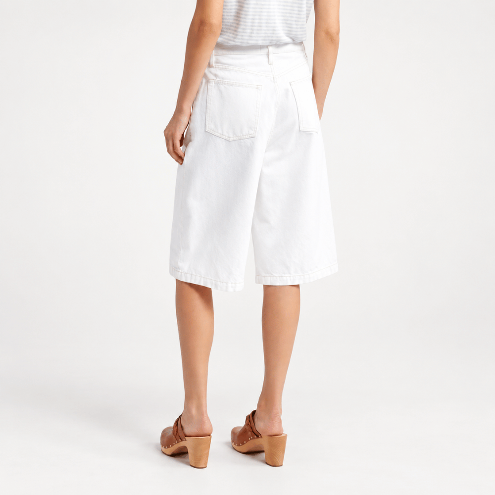 FRAME The Boy Shorts in Au Natural Clean at Riada Concept. Mid-rise long white denim shorts in rigid regenerative cotton for summer - back view