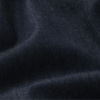 Close-up of dark navy blue fabric with a fine woven texture and soft folds - FRAME The Denim Balloon Pant in Rinse at Riada Concept. High-rise balloon jeans in fluid cotton-lyocell denim with a gathered ankle