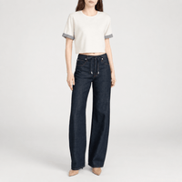 FRAME The Off Duty Drawstring Bow Jeans in Rinse at Riada Concept. High-rise fluid denim with a curved leg and drawstring waist - front styled model view