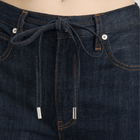 Close-up of FRAME The Off Duty Drawstring Bow Jeans in Rinse at Riada Concept. High-rise fluid denim with a curved leg and drawstring waist - with drawstring and button details.